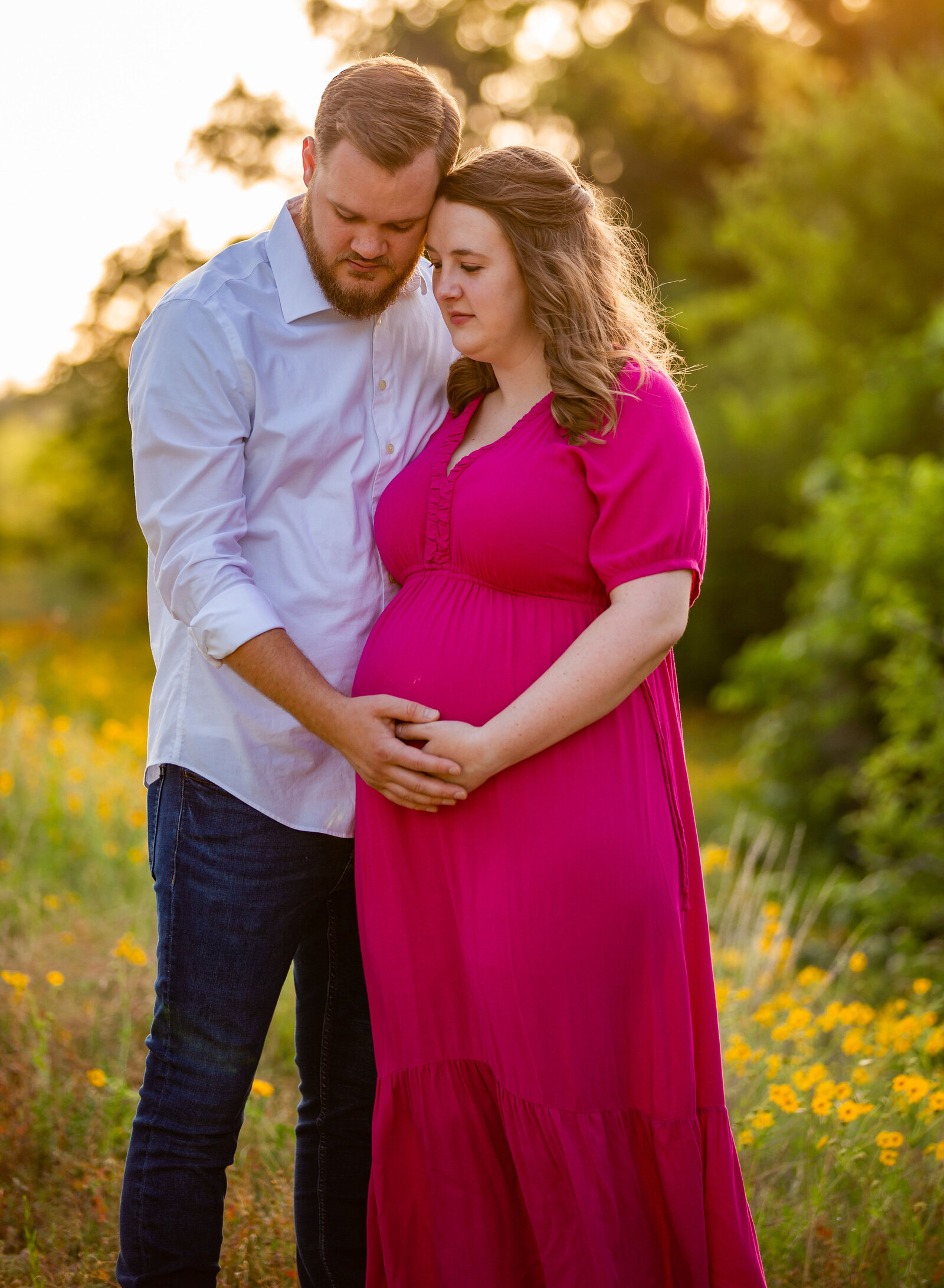 couple focused on maternity belly