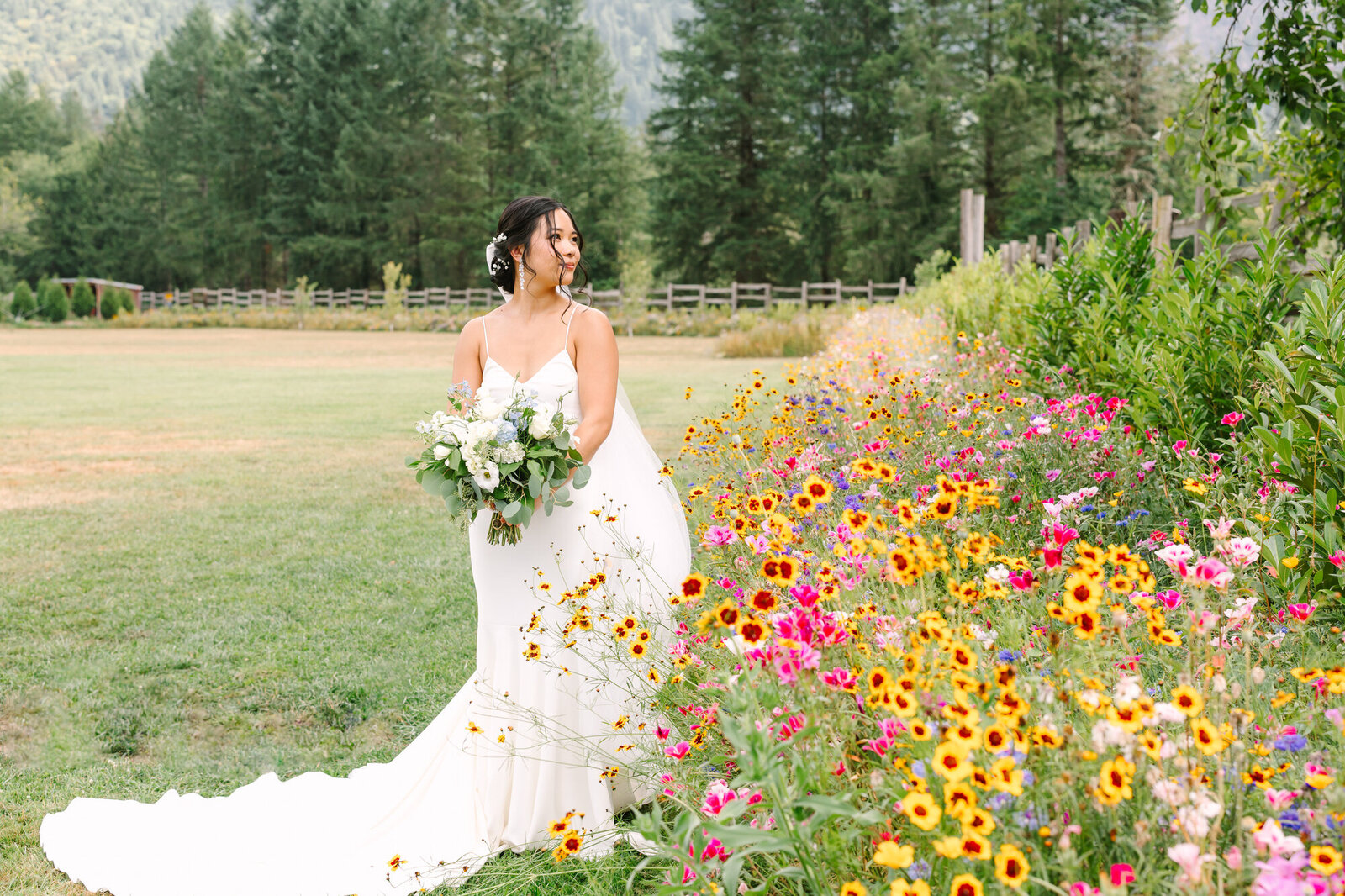 bride standing in front of wild flowers at mount si