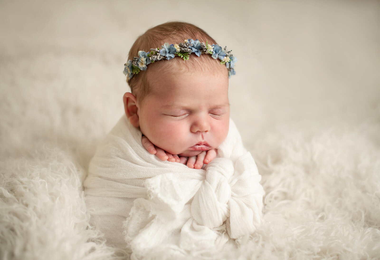 Sleeping newborn girl in  potato sack pose with white background and accessories