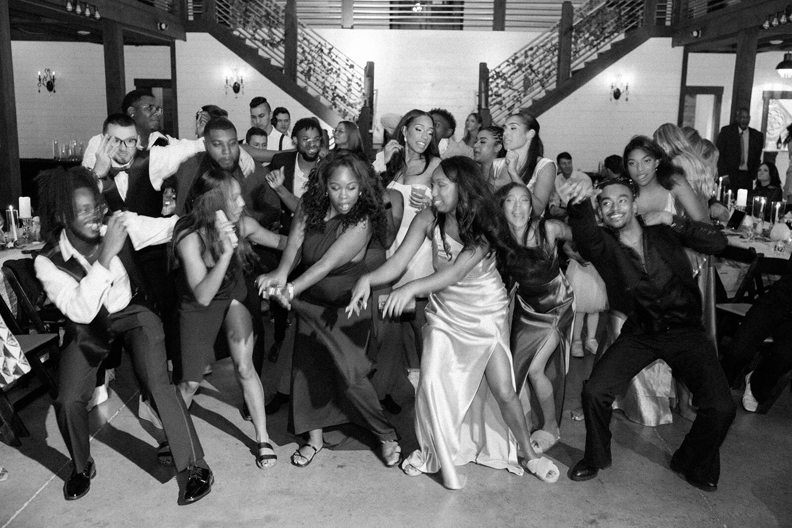 Wedding guests dance together during reception at New York style wedding.