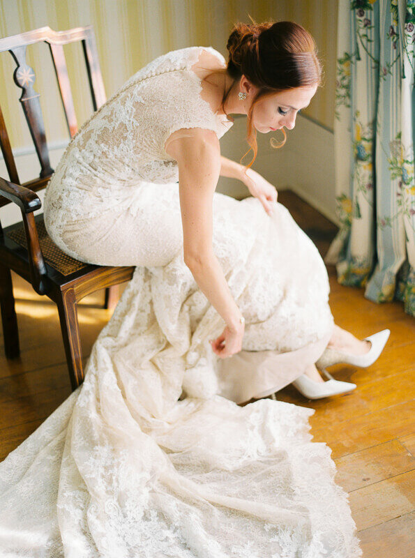 bride getting ready with pronovias wedding dress and budgley mishka shoes in palacio bussaco portugal