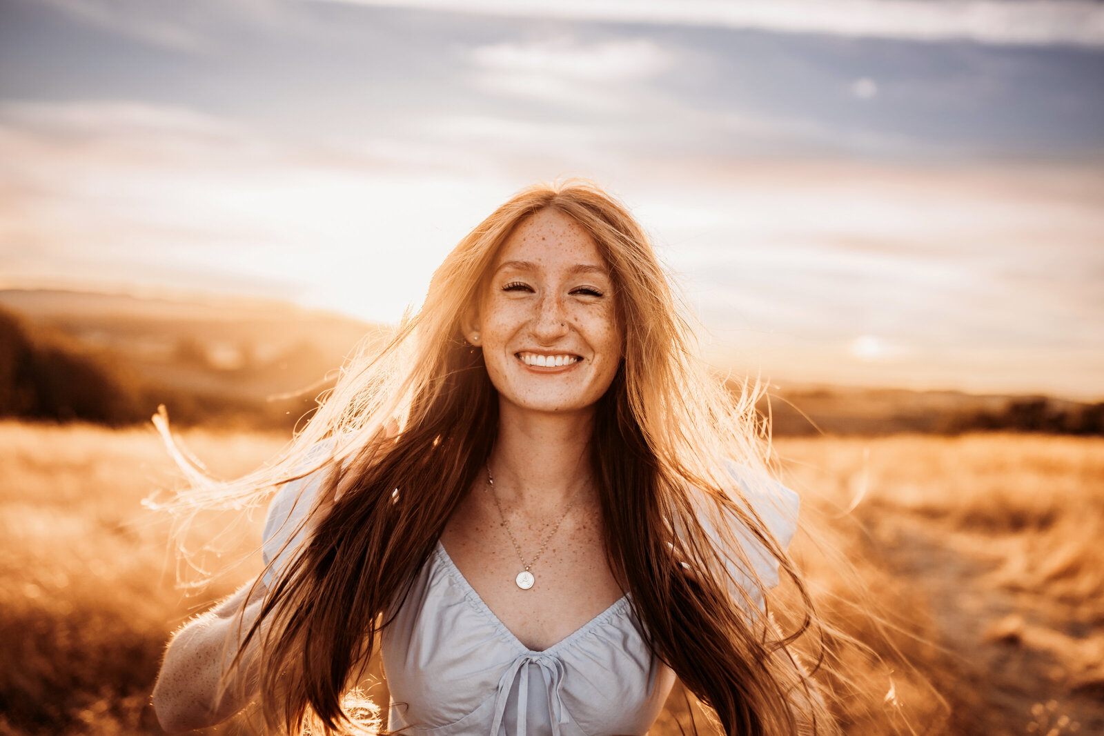 Salem Senior Photographer, girl with long red hair standing in field at sunset