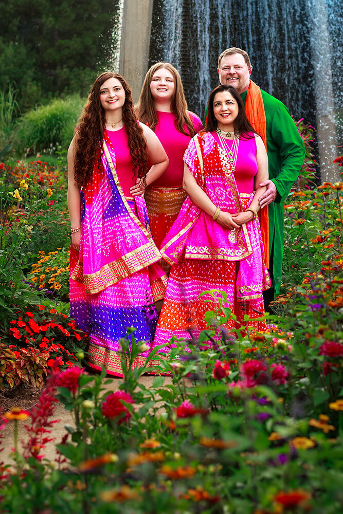 inidan-family-photos-denver-botanic-garden-waterfall-blue-flowers-warm-colors-red-yellow-orange-purple-cultural-heritage