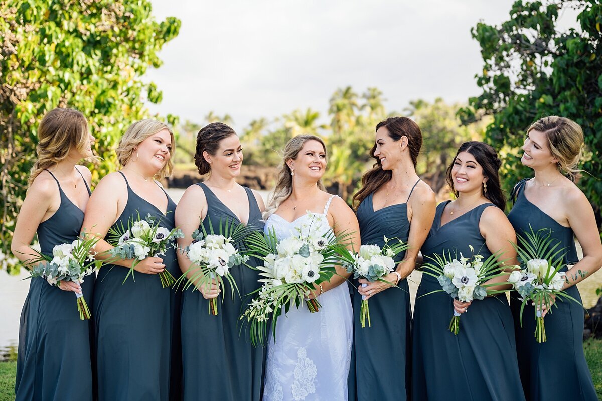 bride and her bridesmaids in blue green dresses during her hawaii wedding at mauna lani