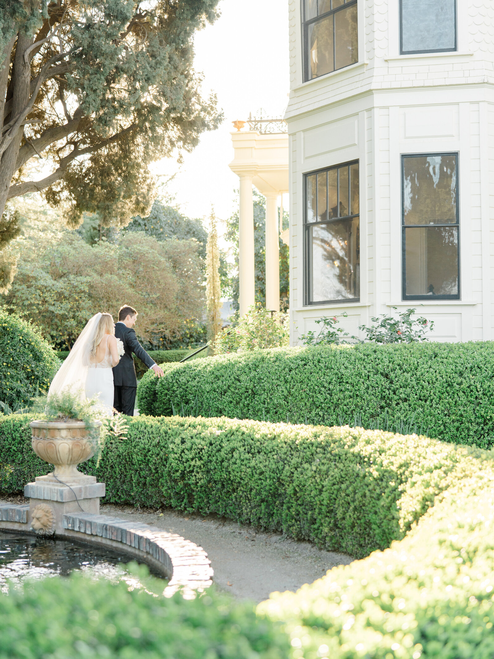 bride and groom walking together in a garden