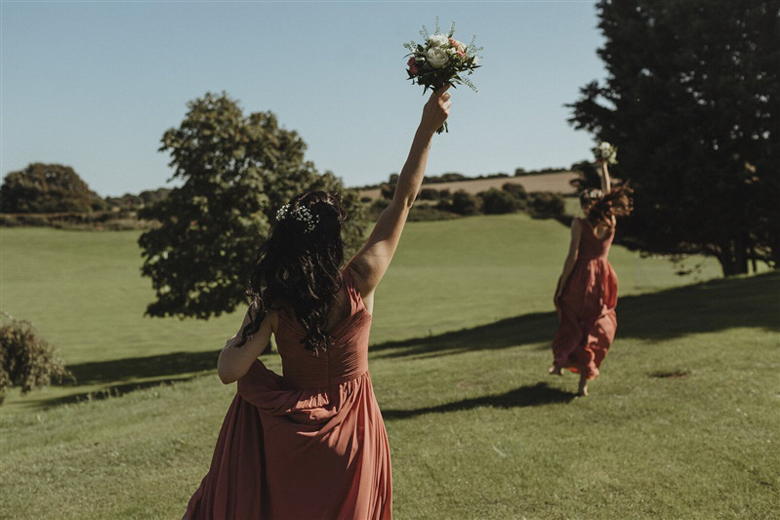 bridesmaids running with flowers