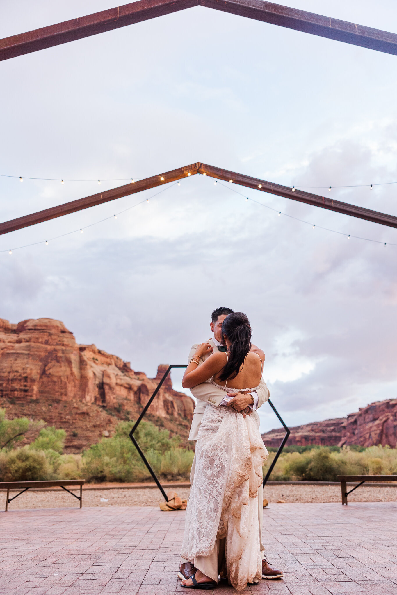 Bride and Groom dance under the blue sky during their wedding