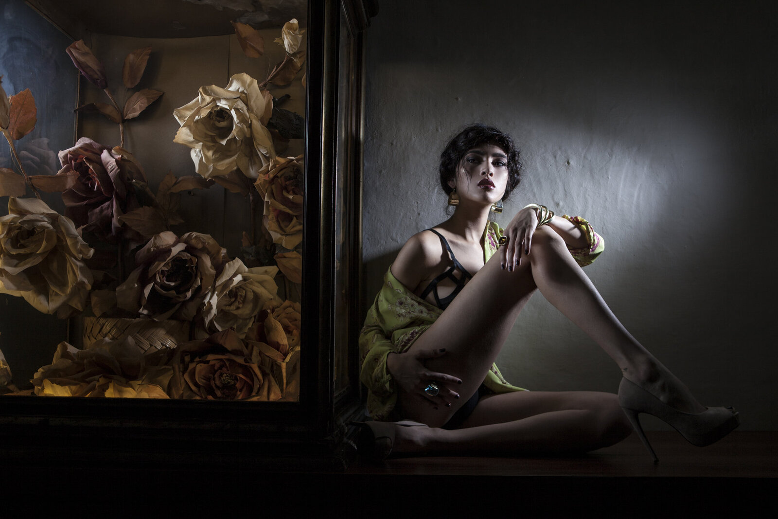 Makeup on model in moody room full of flowers