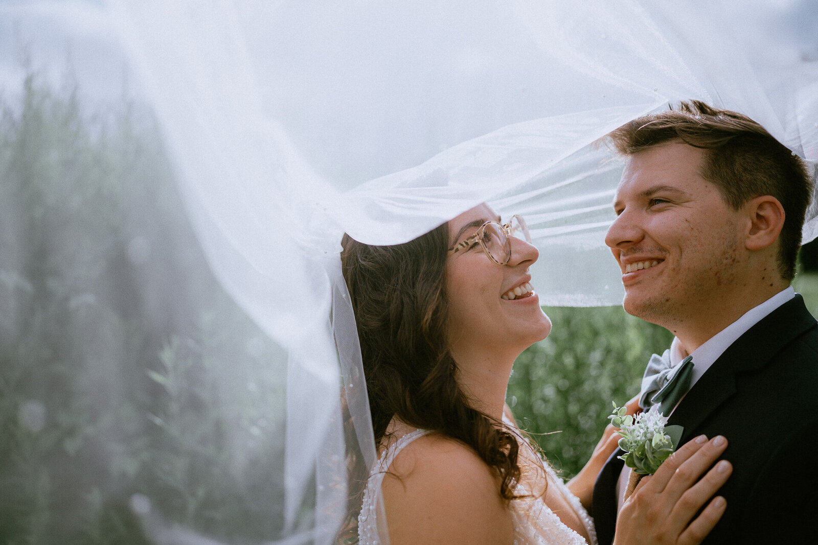 bride-groom-under-veil-sunlight