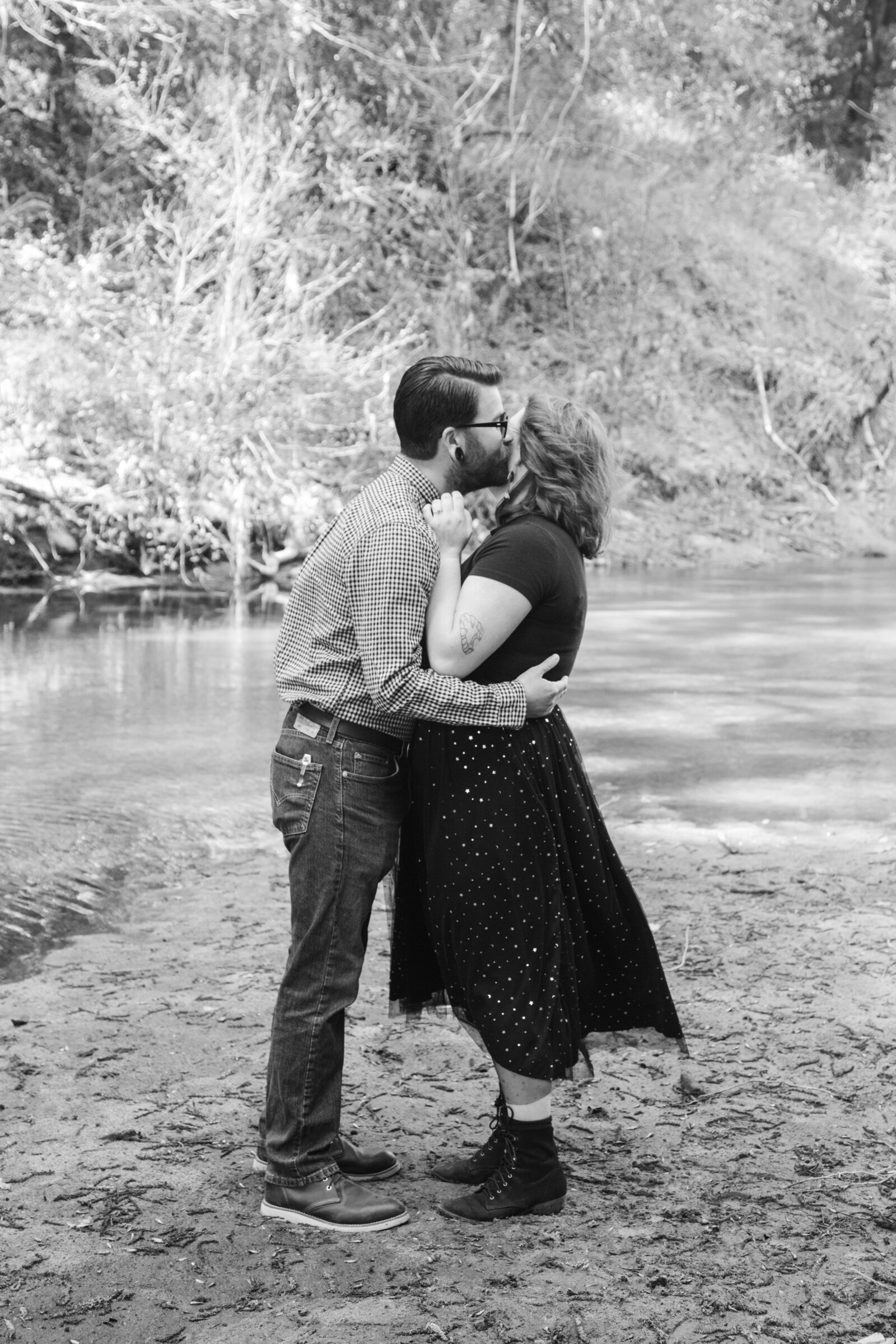 An tattooed engaged couple poses for photos in a redwood forest in Santa Cruz, Ca.