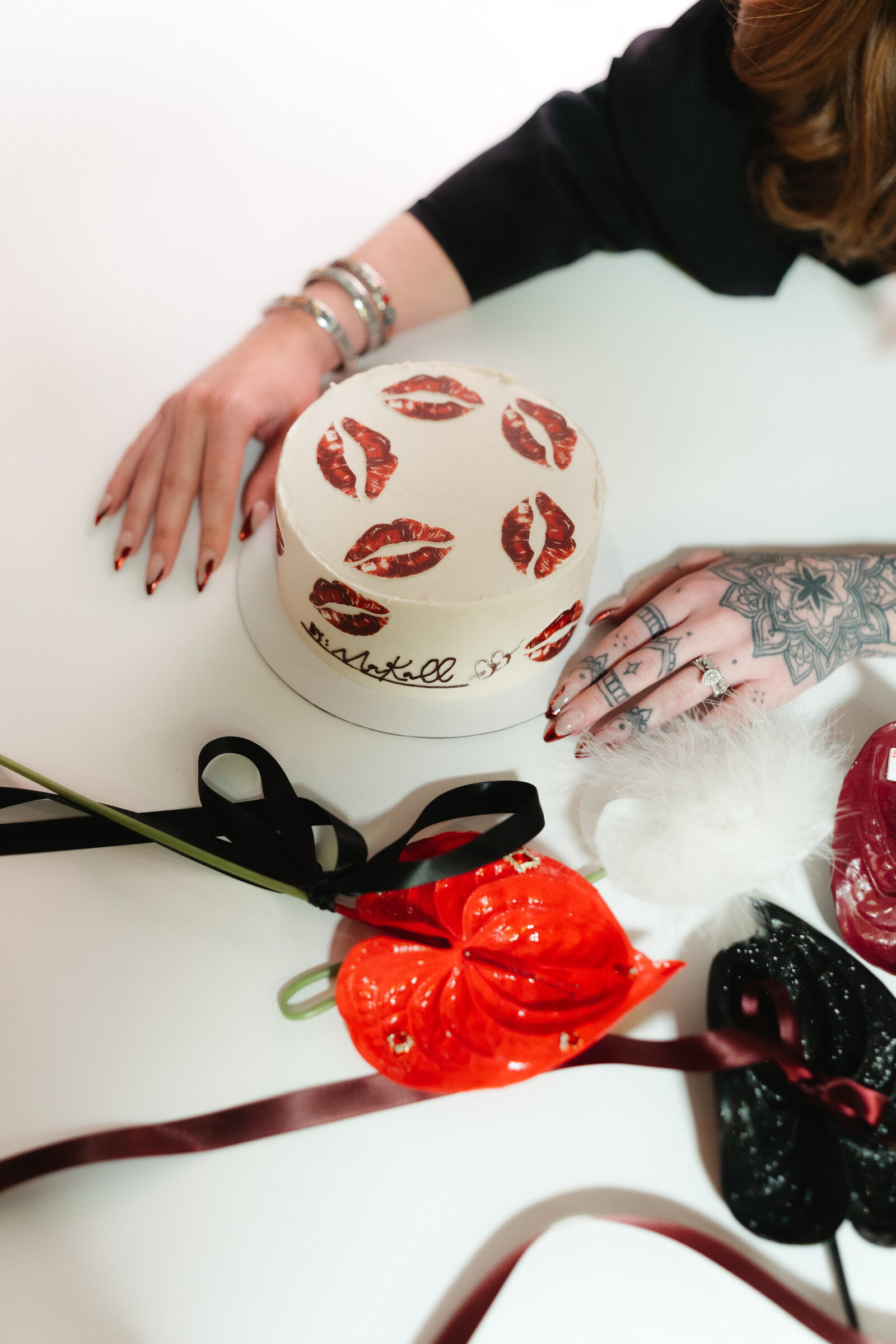 collage of five-star bridal testimonials overlaid on a lipstick-kiss patterned brand cake
