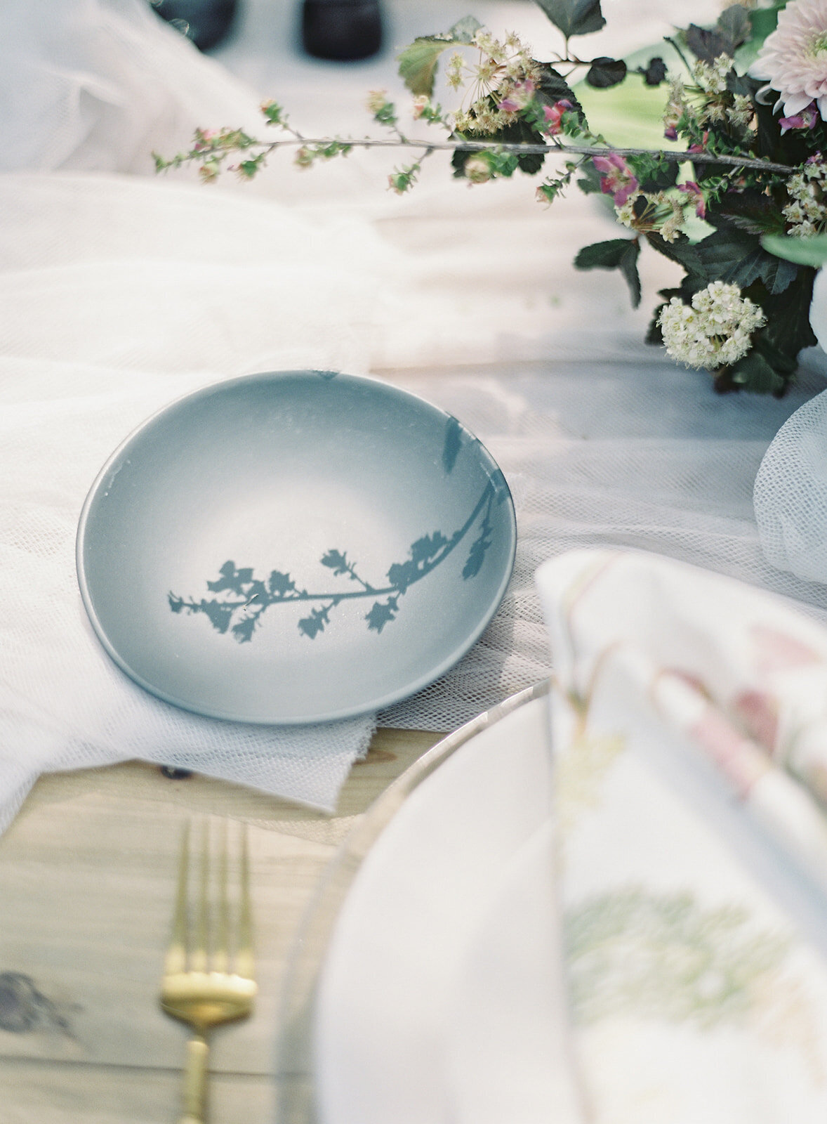 Shadow of floral stem on bread plate. Photographed by wedding photographers in Charleston Amy Mulder Photography