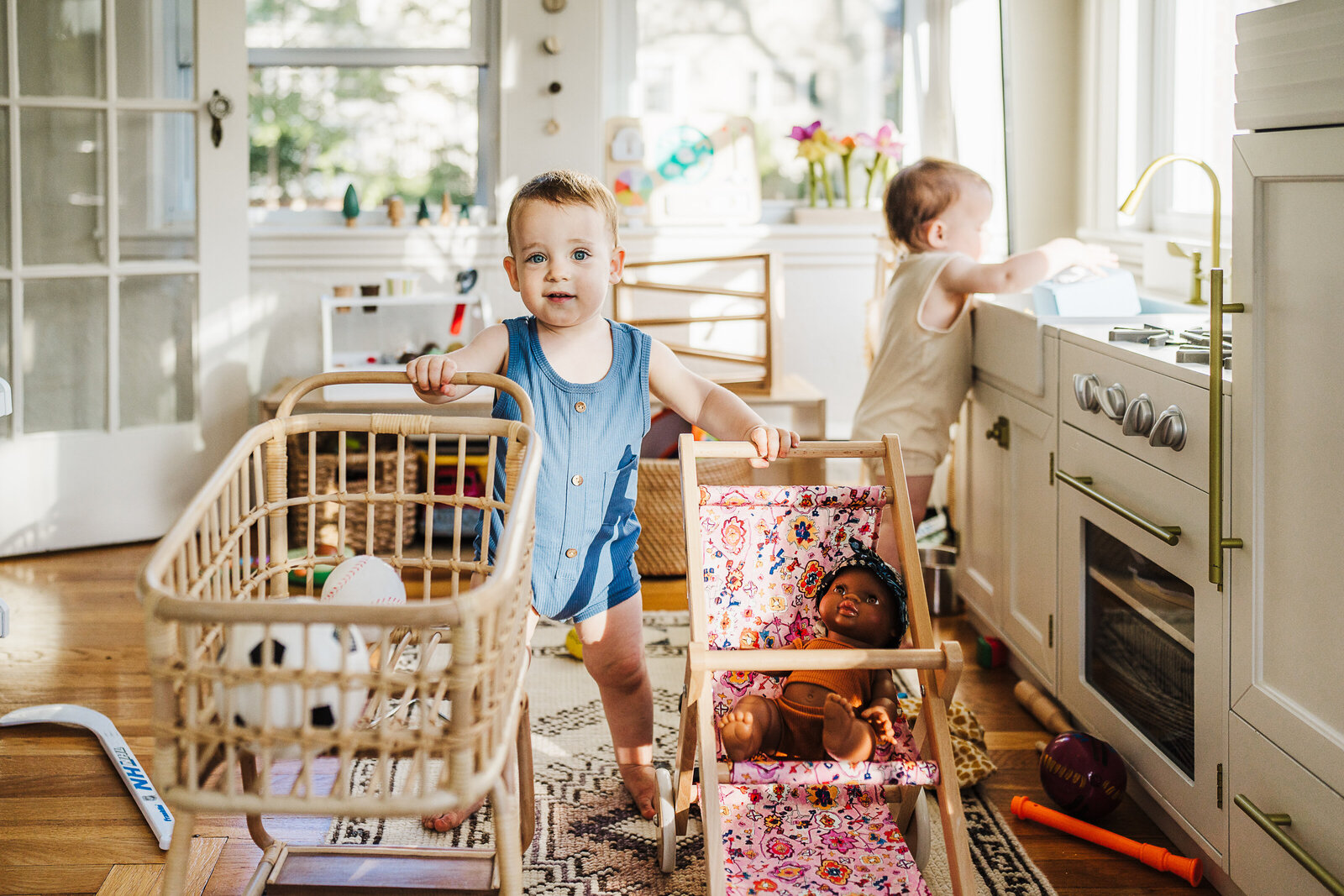 toddler boy pushes strollers