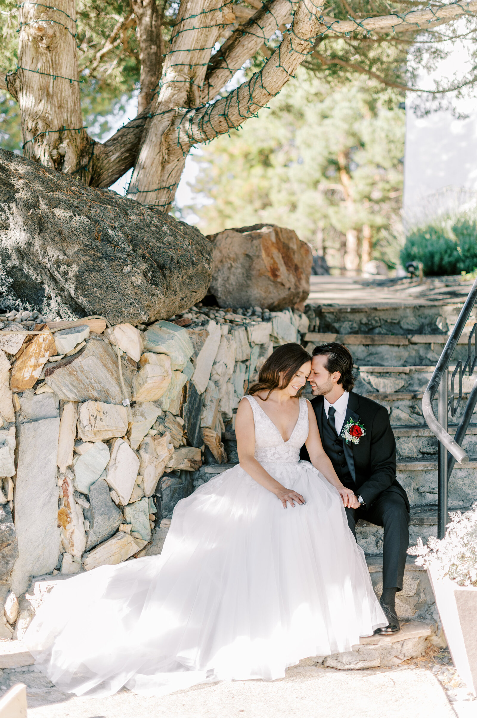 Boise wedding photography at Stone Crossing with bride and groom sitting and cuddling on stairs