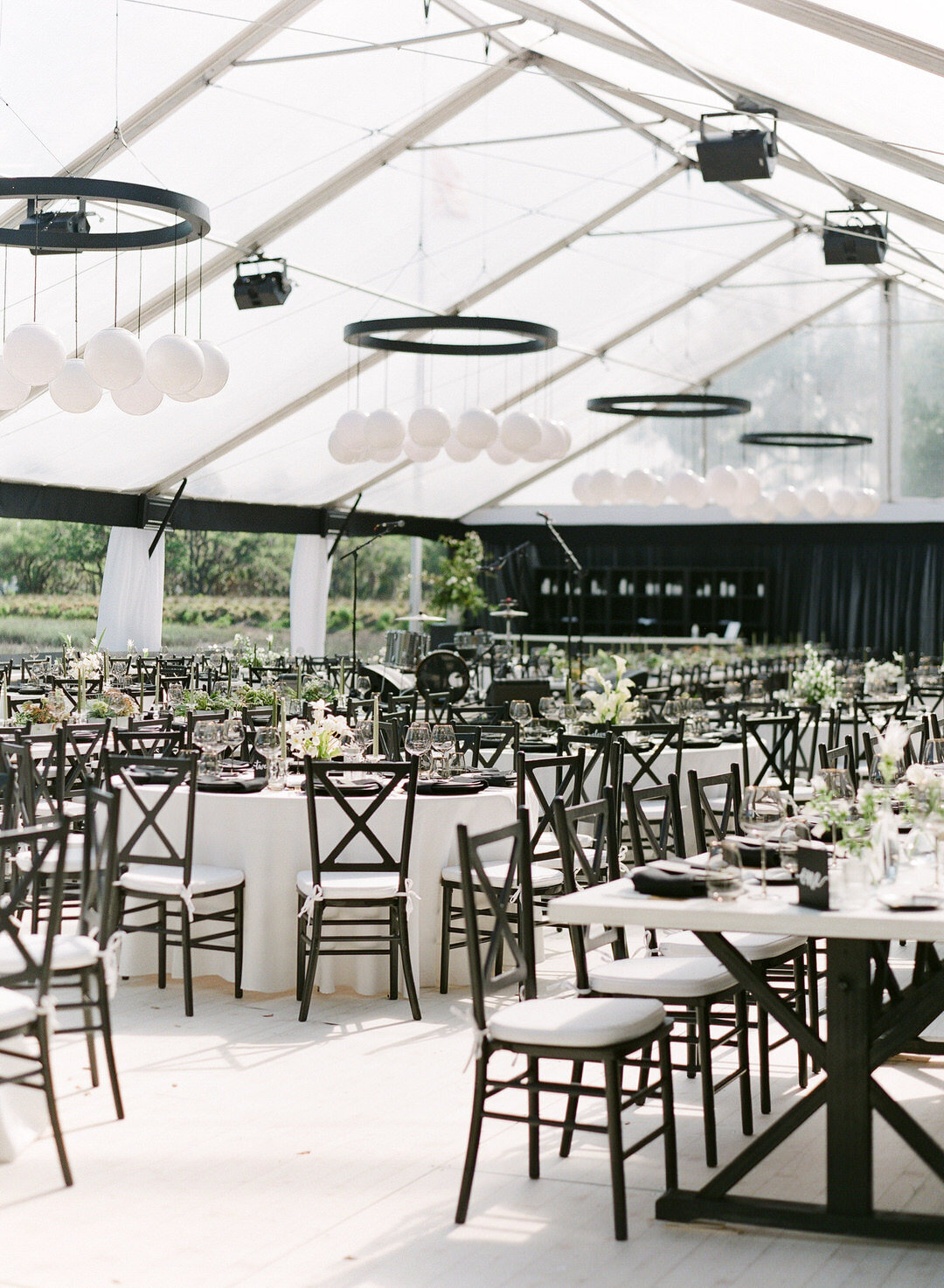 Wedding Reception Tent with Black and White Decor and Greenery