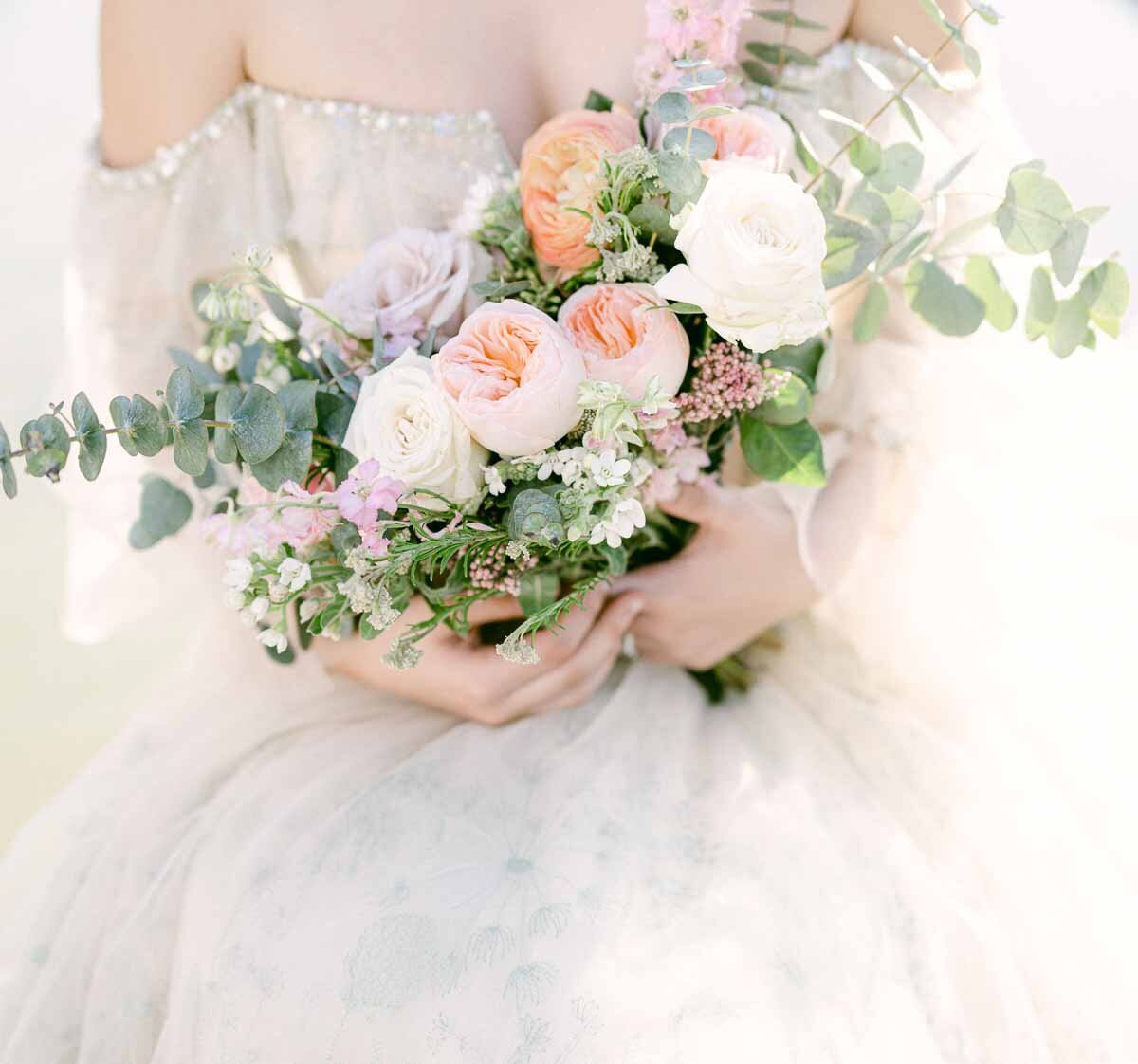 close up photo of bride holding wedding bouquet