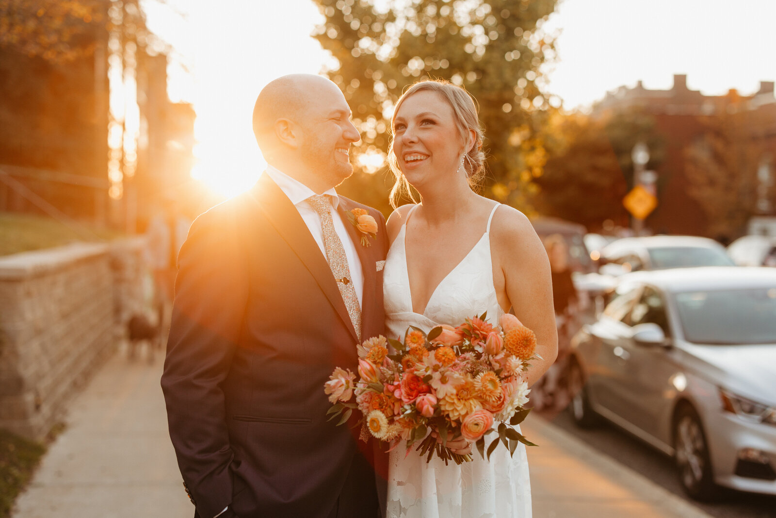 Bride and groom happy together during sunset photos outside of the Dogwood wedding reception in St. Louis