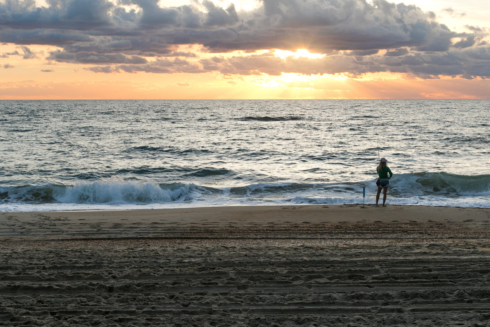 girl fishing on Avon Beach NC at sunrise