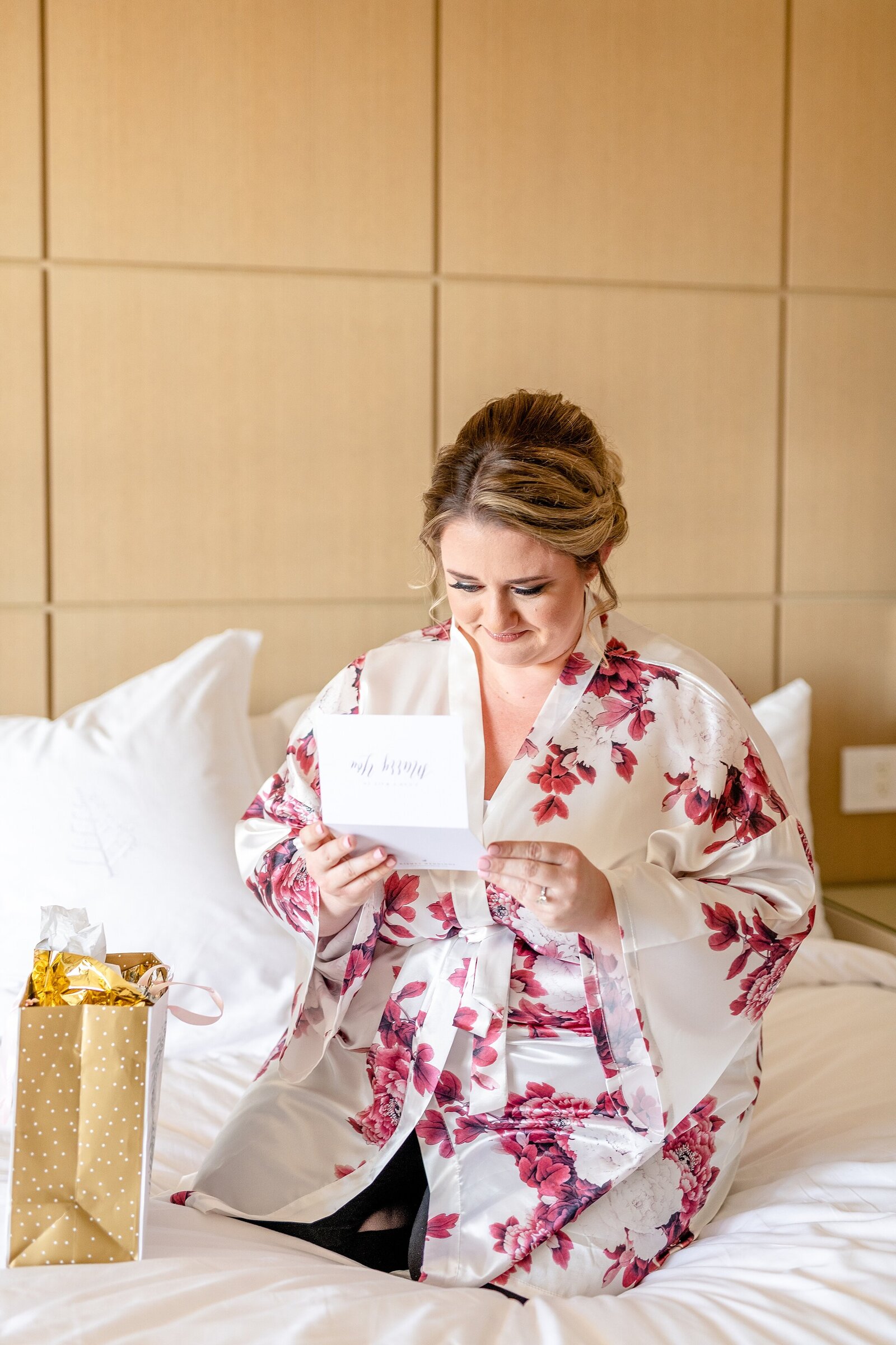 Bride opening gift on wedding day | Four Seasons Wedding | Chynna Pacheco Photography