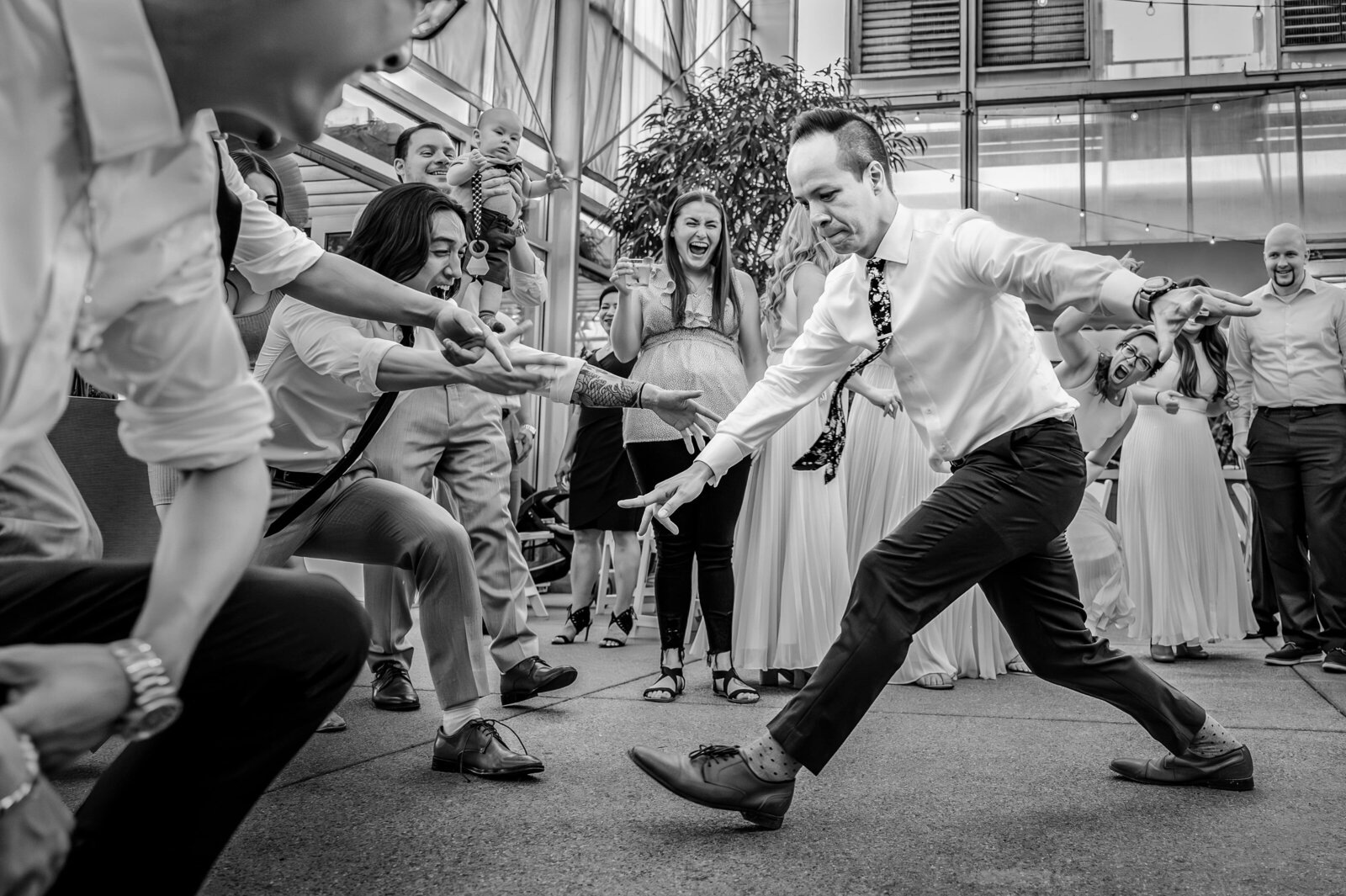 Groom busts a move while break dancing at the reception.