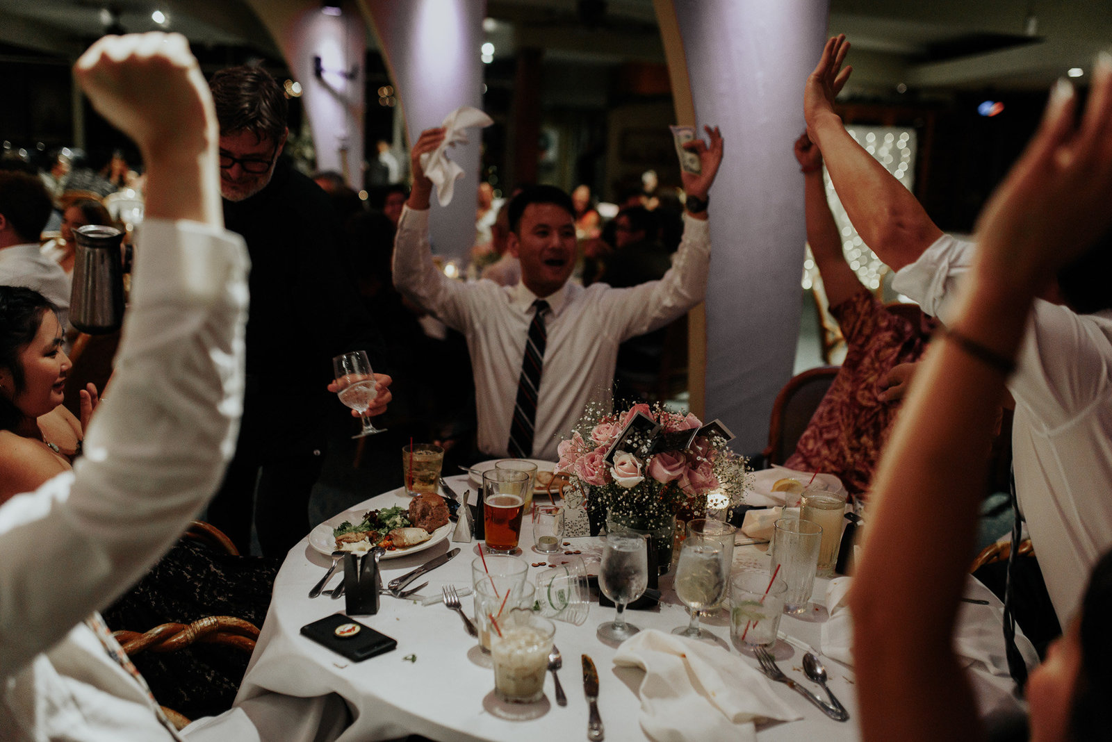 fun photo of the wedding party dancing and celebrating
