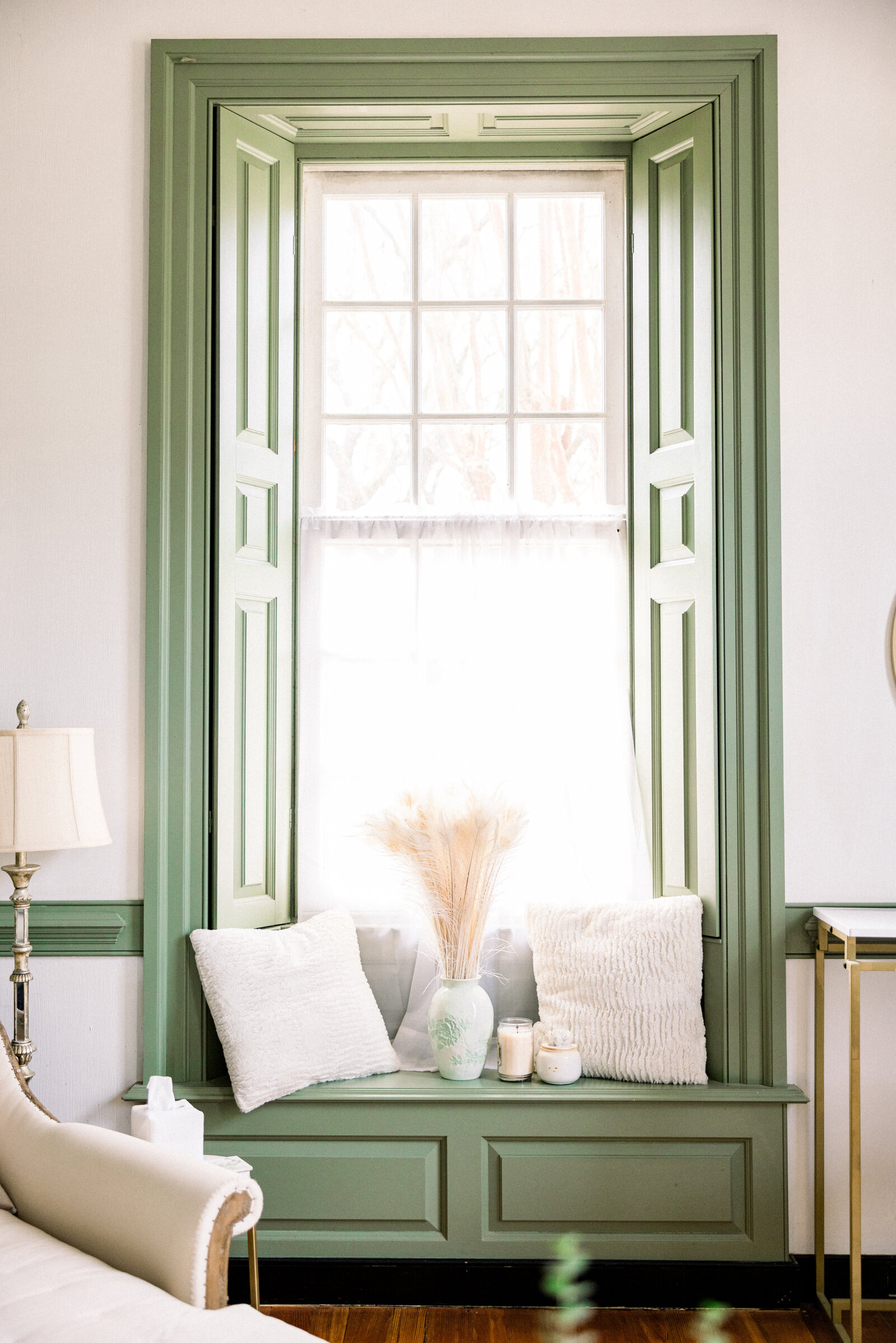 A beautifully crafted green window seat at the historic replica house in Inola, Blue Ridge, GA, offering a charming and romantic setting for a wedding.