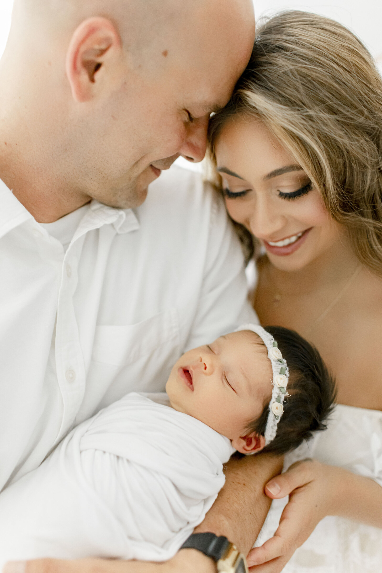 dad embracing mom holding newborn baby taken by nj newborn photographer