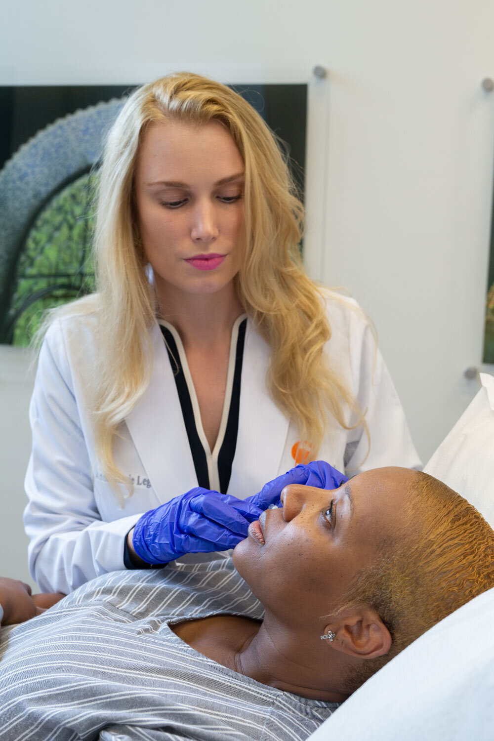 Dermatologist treating her patient