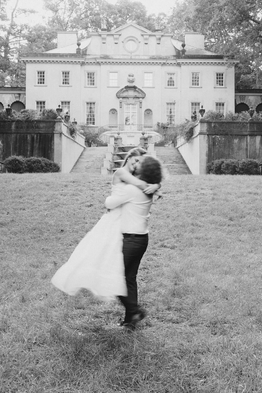 Groom twirls bride on the back lawn of the Atlanta Swan House