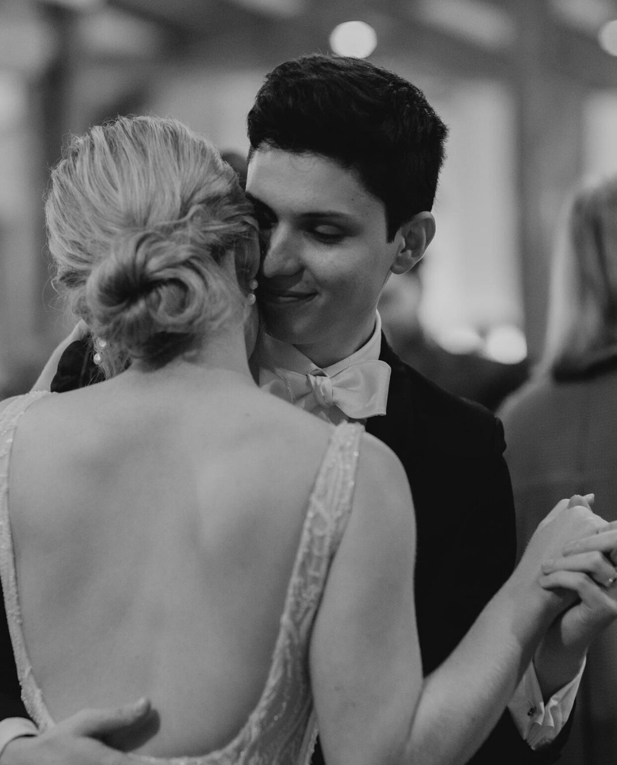 Bella Rae Bride Abby with a textured twisted bun dancing with her husband at Bellingdale Farm captured by Chasing Moments Photography