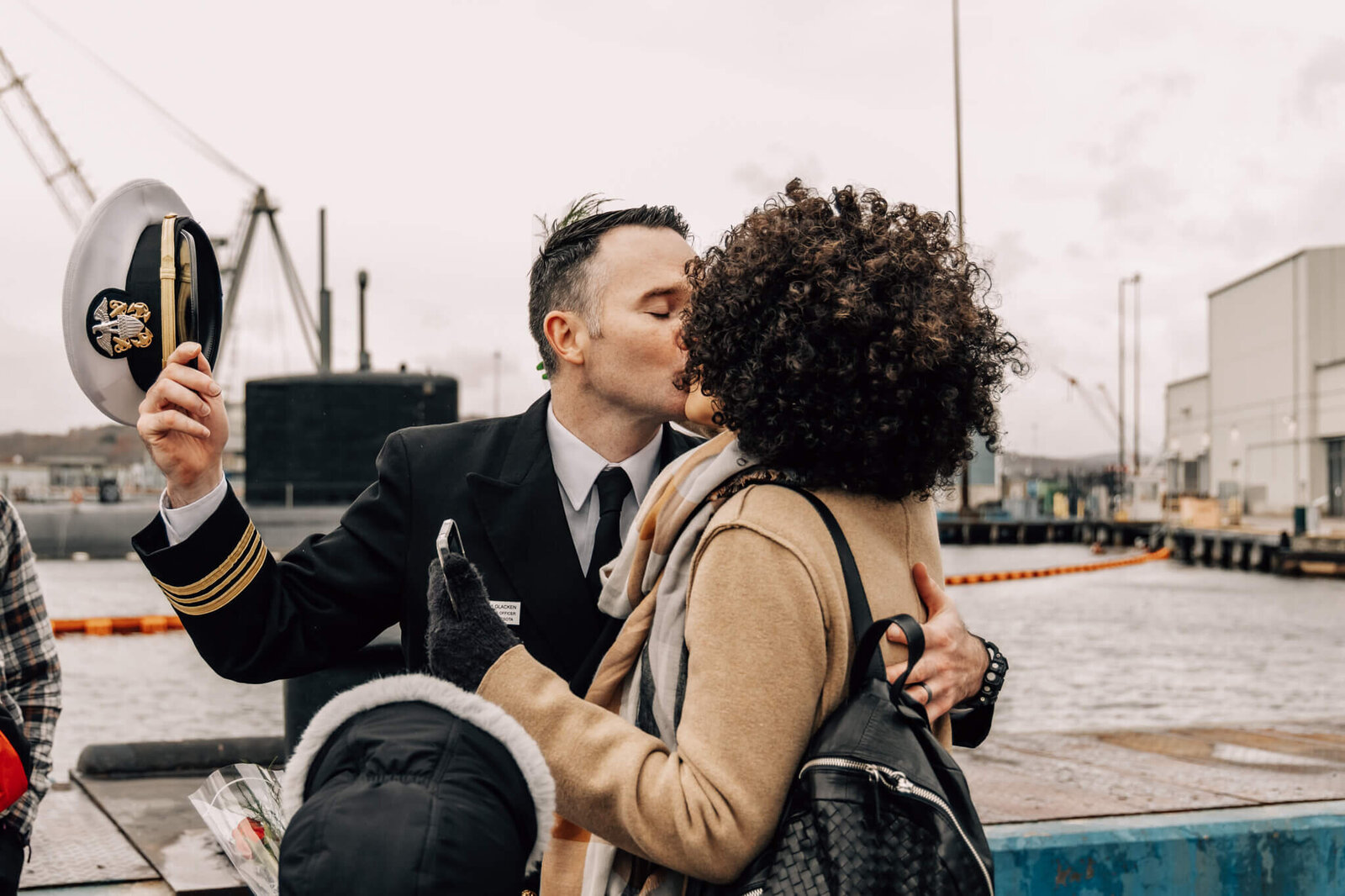 Naval officer kisses wife at USS Minnesota homecoming in Groton, CT.