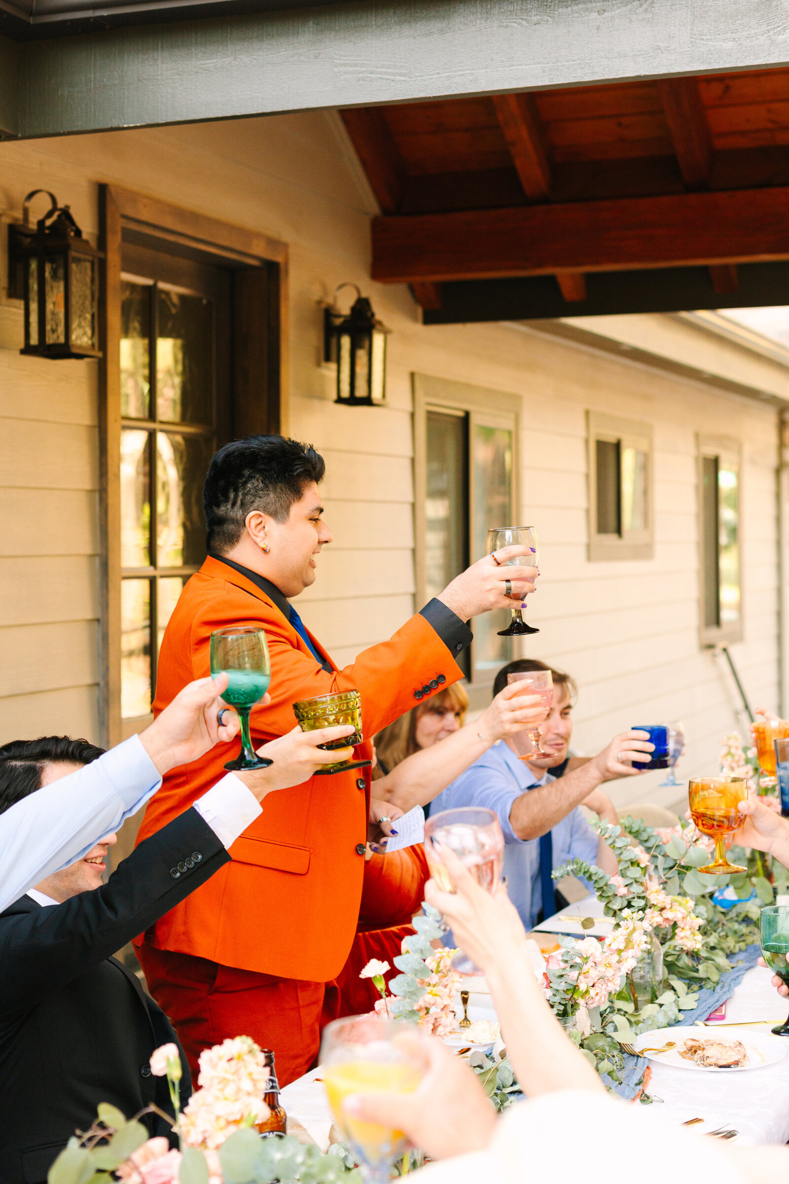 The bridal party celebrates an intimate elopement at a cabin at Big Bear Lake, California.