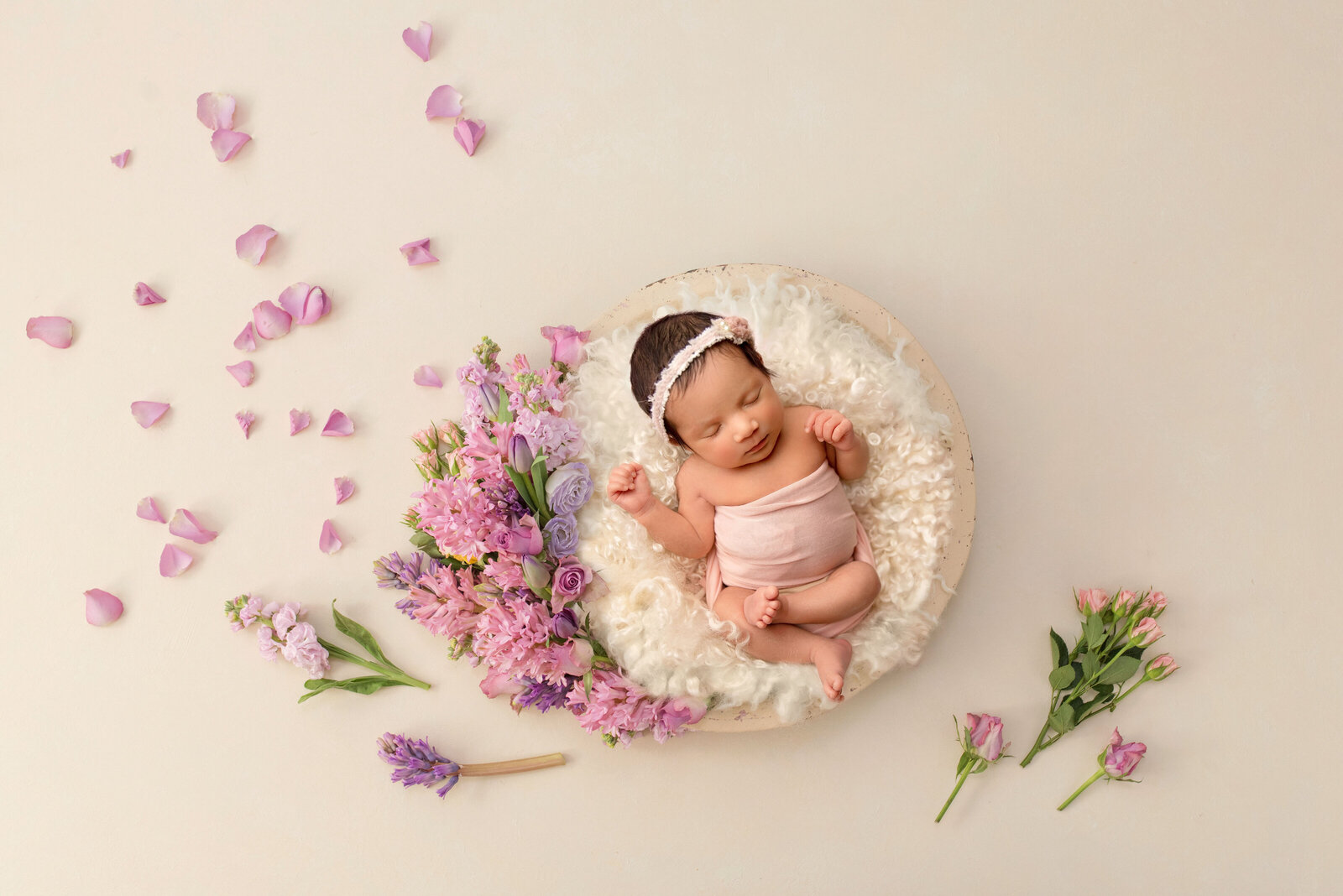 Newborn baby girl in fresh flowers copy