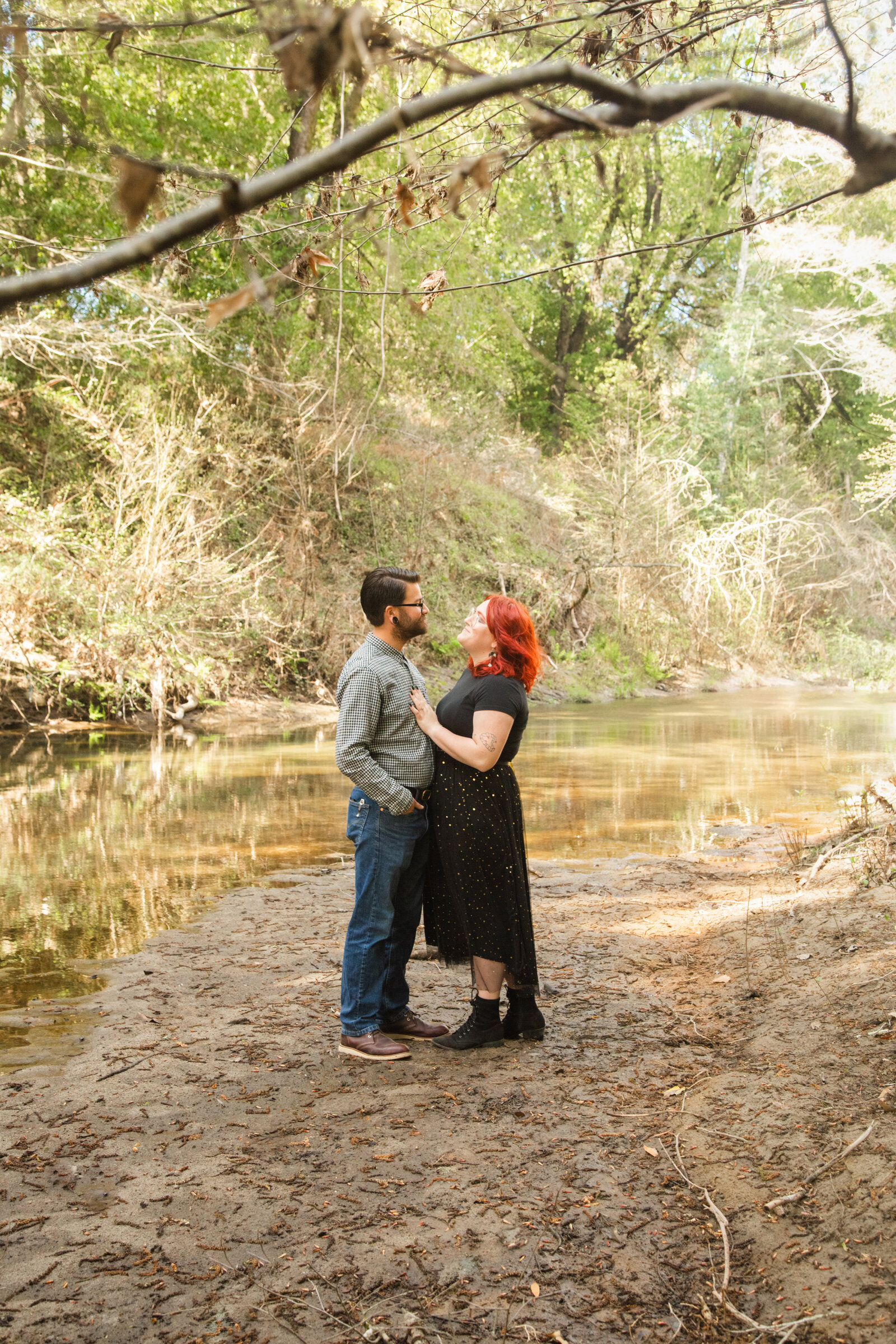 An tattooed engaged couple poses for photos in a redwood forest in Santa Cruz, Ca.