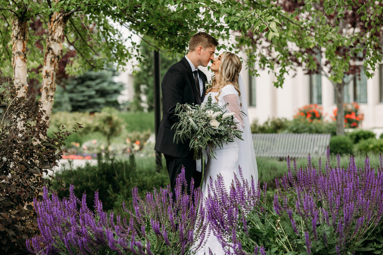 wedding couple standing in purple flowers