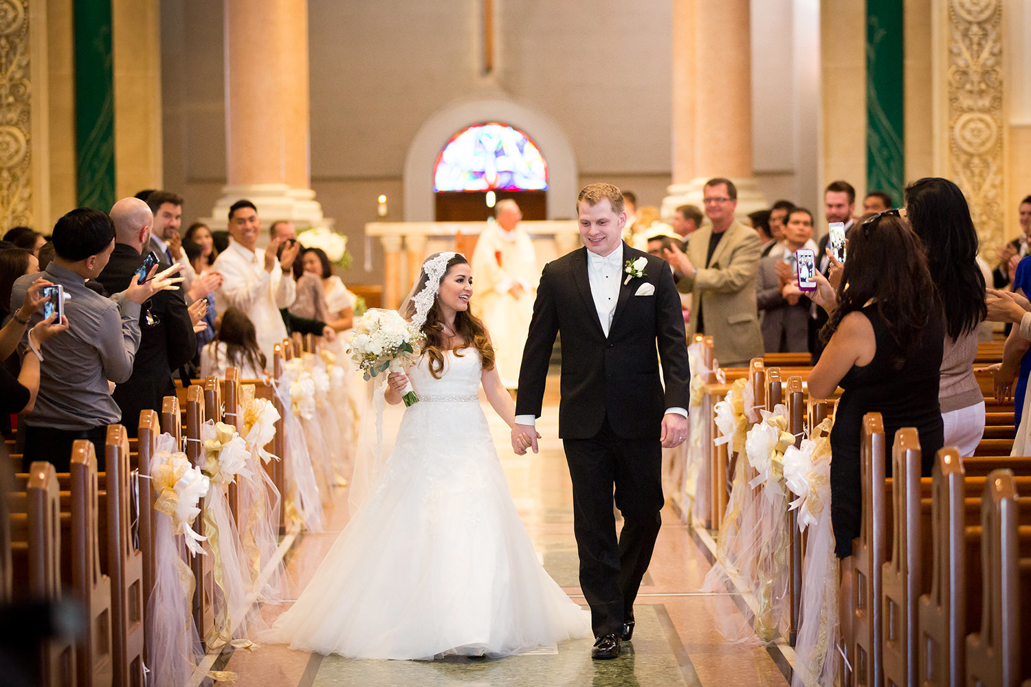 couple walking out of the immaculata of their i do's