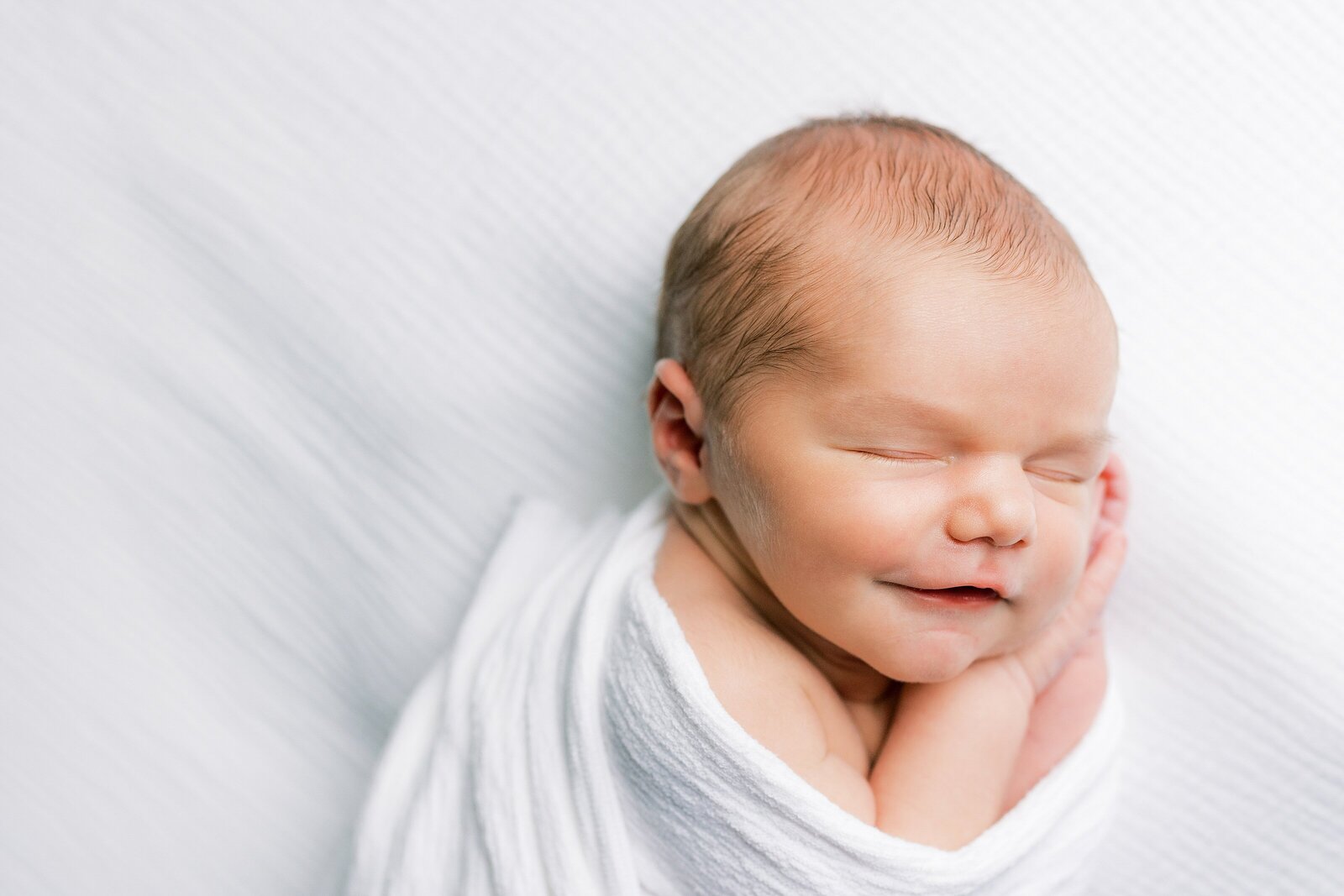 baby smiling while sleeping Newborn Photography West Chester PA