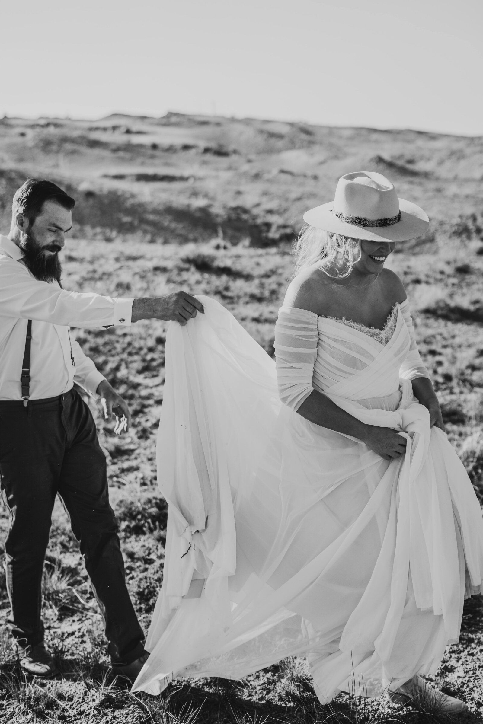 groom holding bride's train