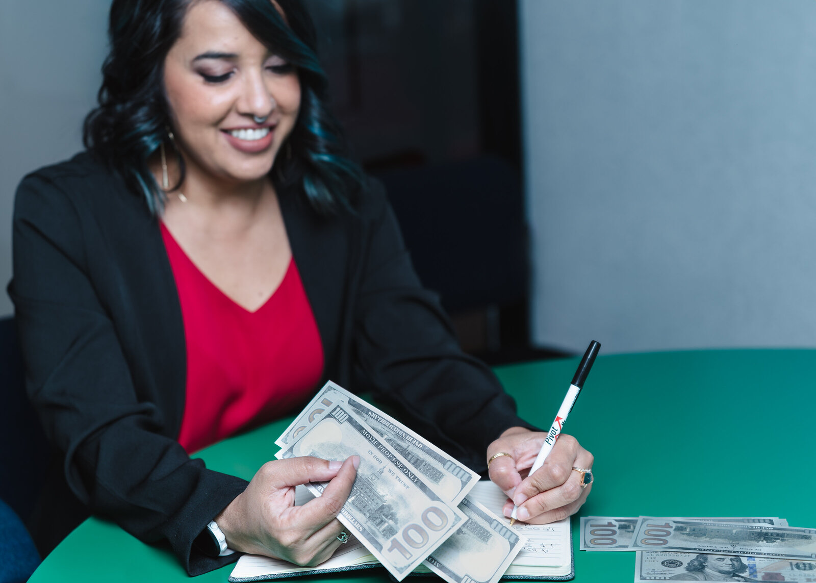 Business Coach takes note and holds dollars