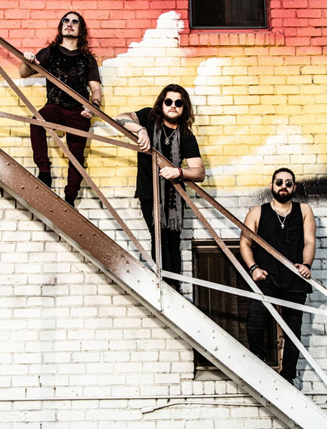 Los Angeles Photographer interview Mark Maryanovich feature Talent In Borders publication band photo three members staggered on metal staircase against brick wall painted white red and yellow page 7