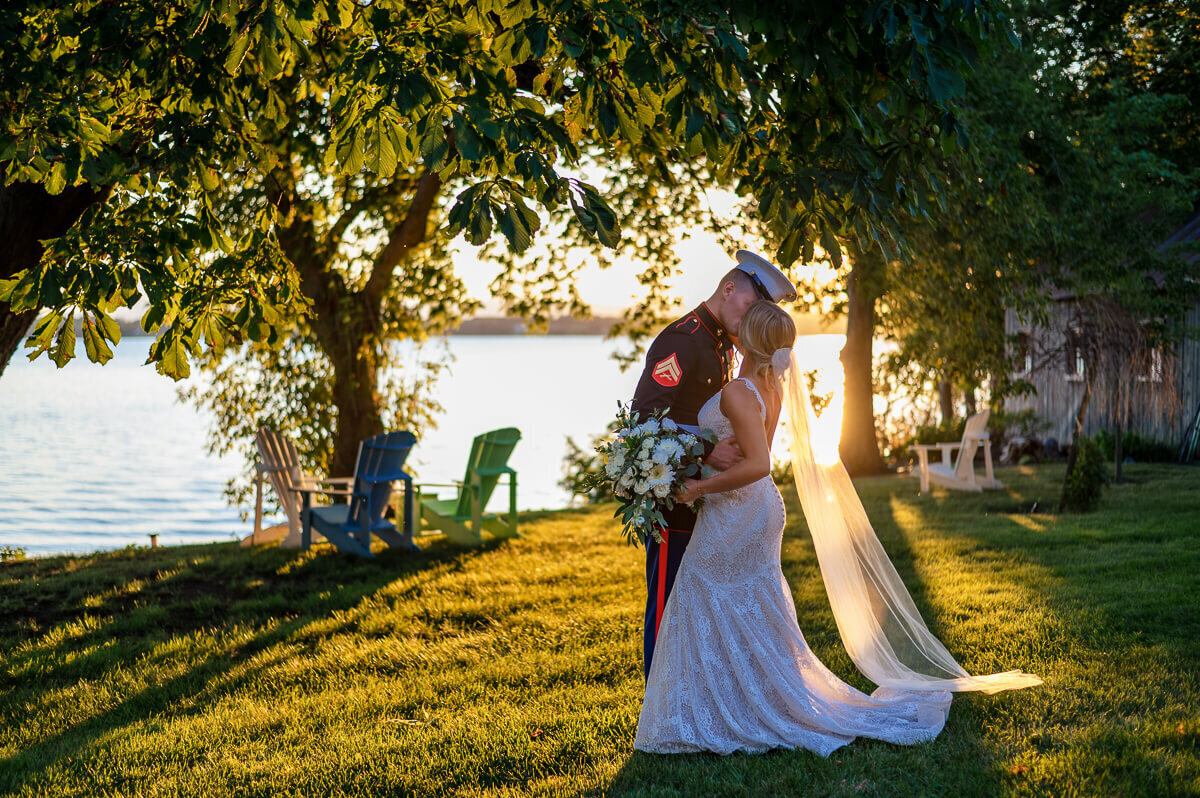 Couple kissing during wedding on lake champlain in vermont