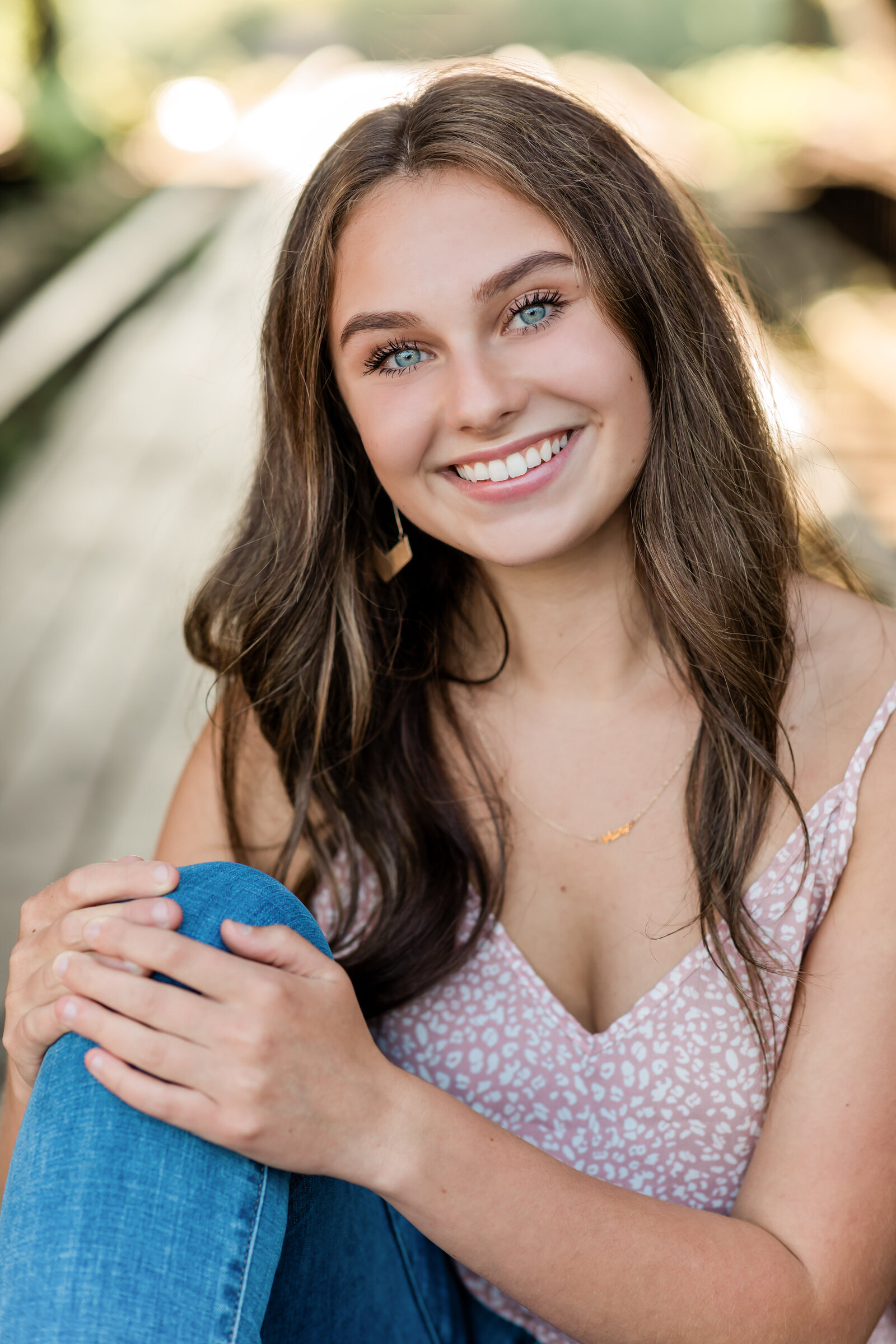 high school senior girl posing for photos at shooters bridge in cleveland