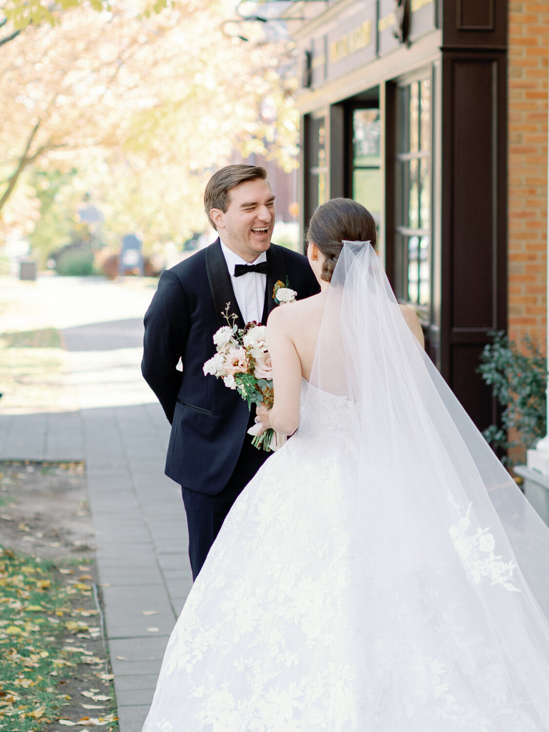 Groom smiling huge at seeing his lovely bride for the first time.