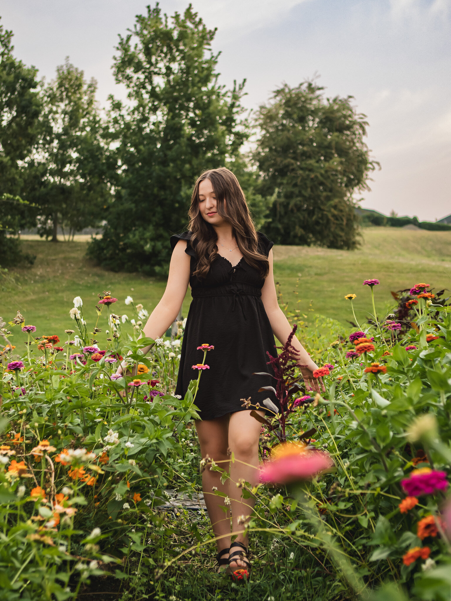 High school senior girl walking through a field of wildflowers in the Columbia Gorge