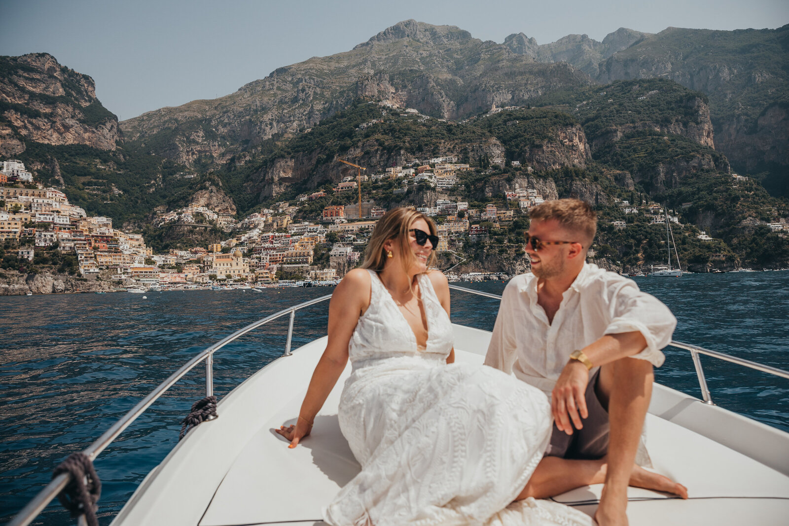 eloping couple pose on a boat in positano