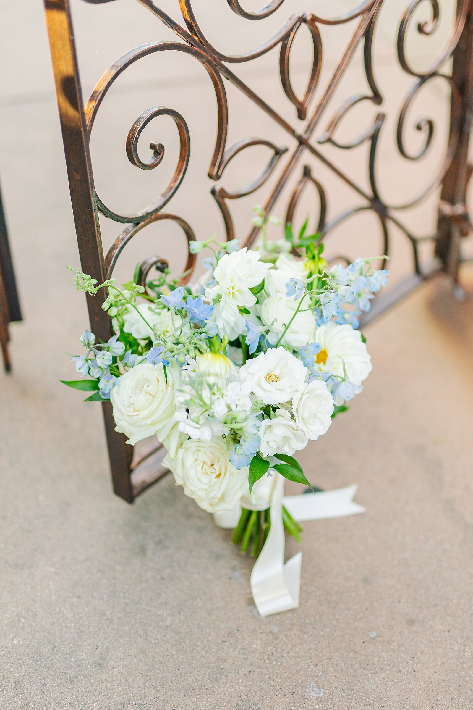 Bridal bouquet on gate at Rancho Valencia wedding venue.