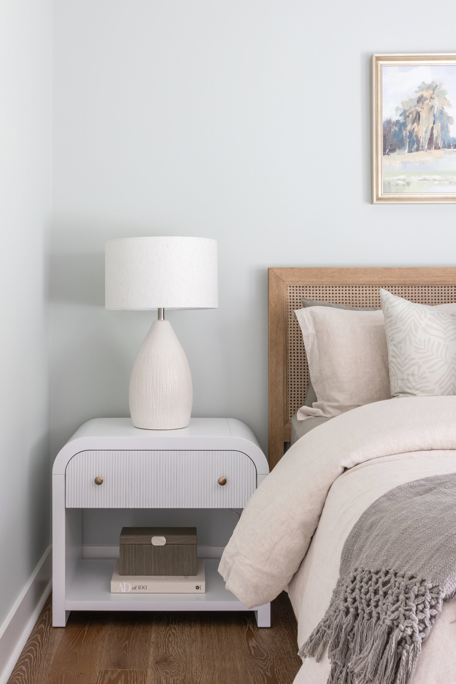Coastal inspired bedroom with cane bed and sea salt walls.