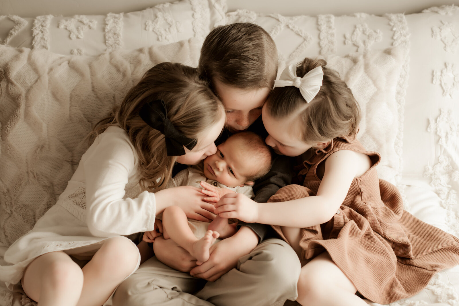 baby photoshoot lifestyle with siblings on bed