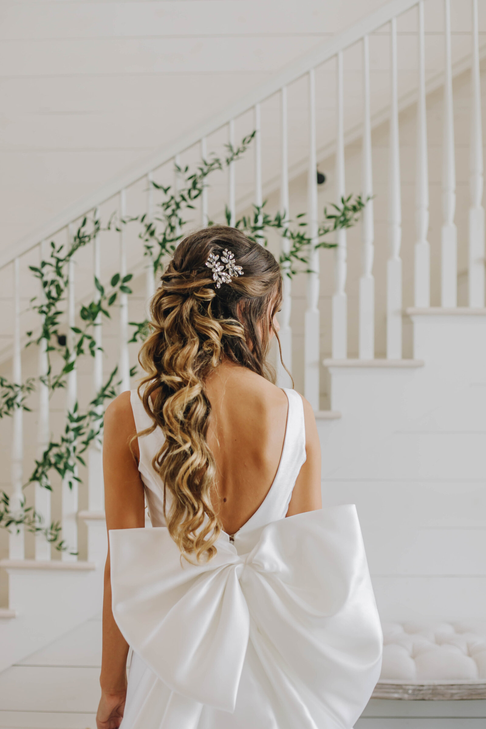 Back of bride in her wedding dress with a big bow on the back