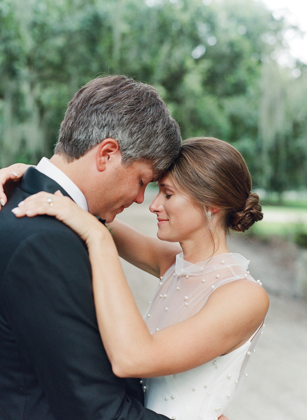 Bride and Groom Hugging with Foreheads together